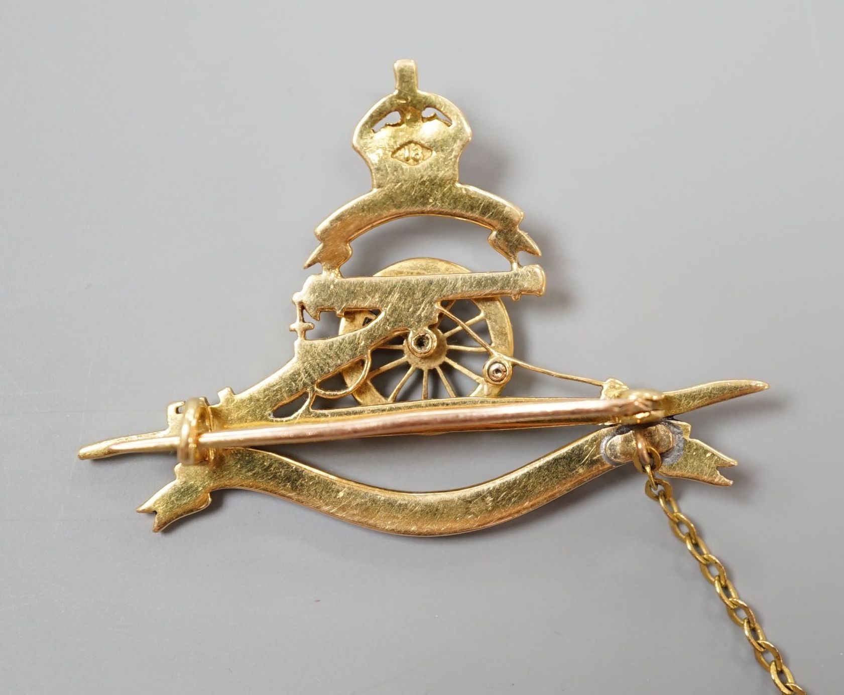 A 20th century yellow metal (stamped 18), enamel and diamond chip set Royal Artillery sweethearts brooch, 43mm, gross weight 8.4 grams.